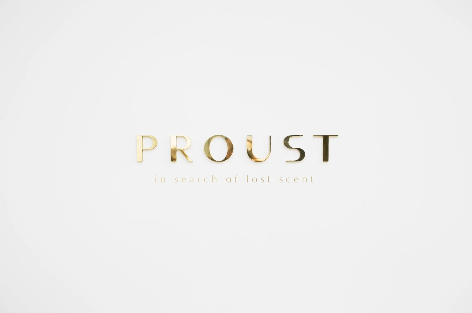 Proust logo in brass letters