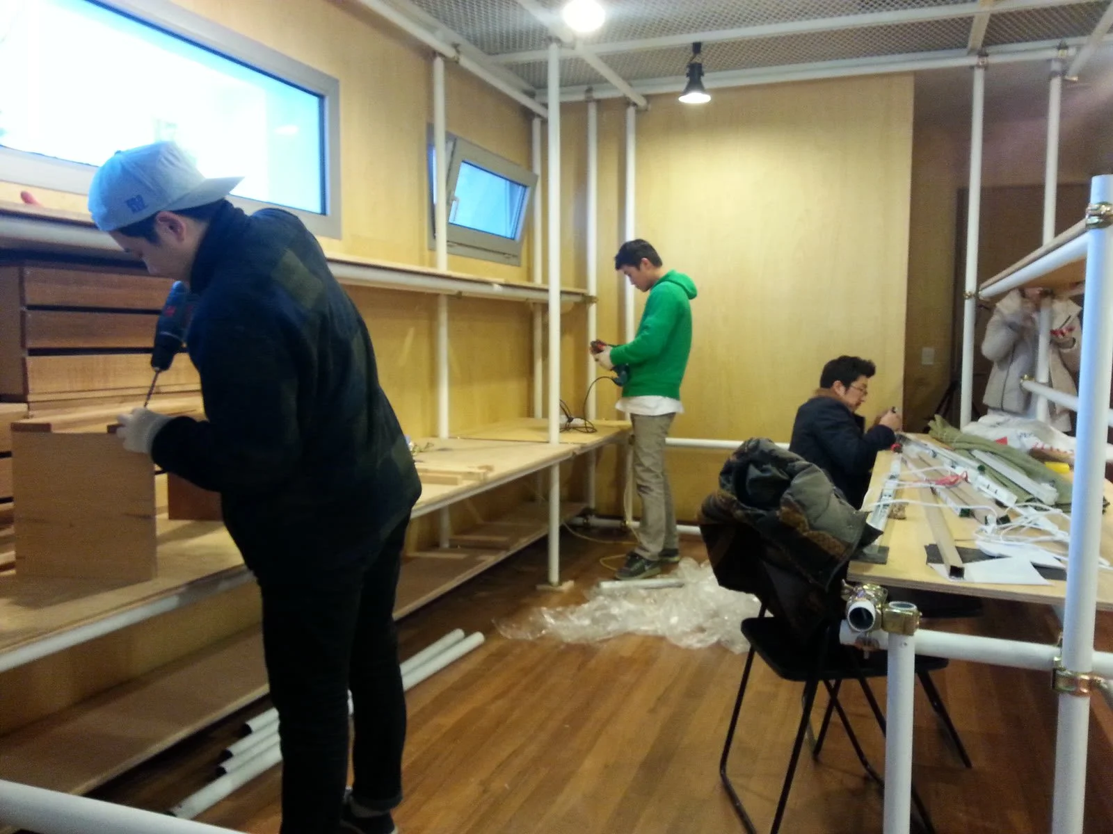 Assembling pipe desks along the wall