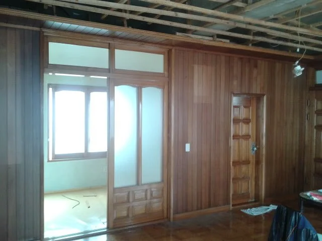 Original guest room with wood-paneled walls and sliding doors