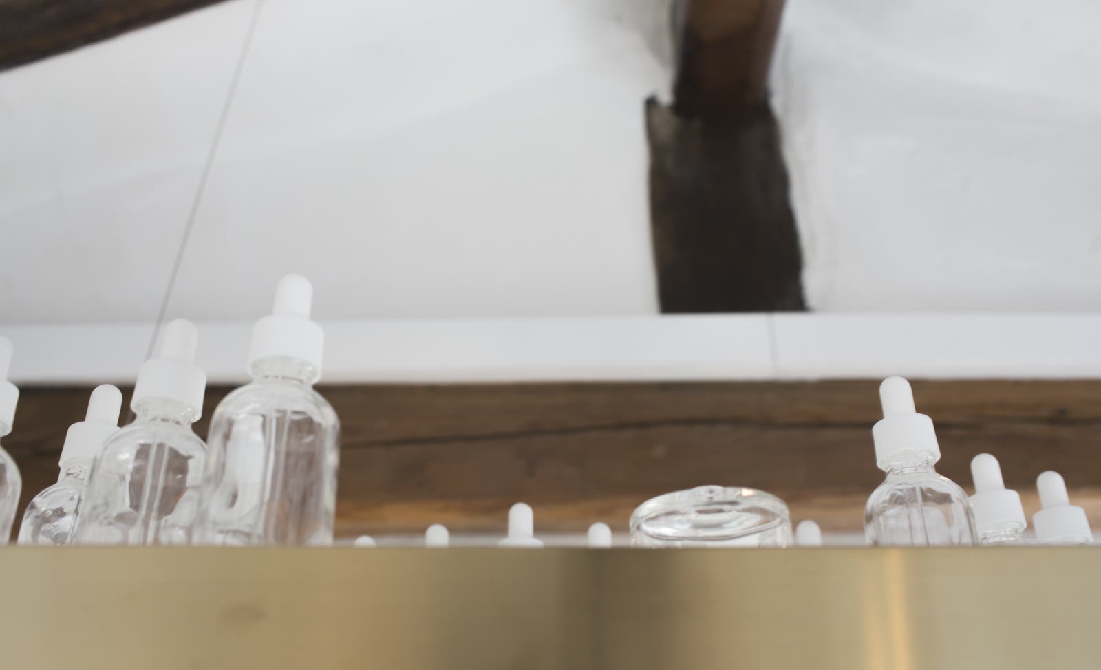 Perfume bottles on a brass shelf