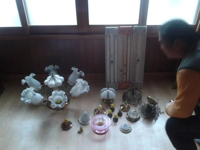 Old light fixtures gathered on the floor for reuse