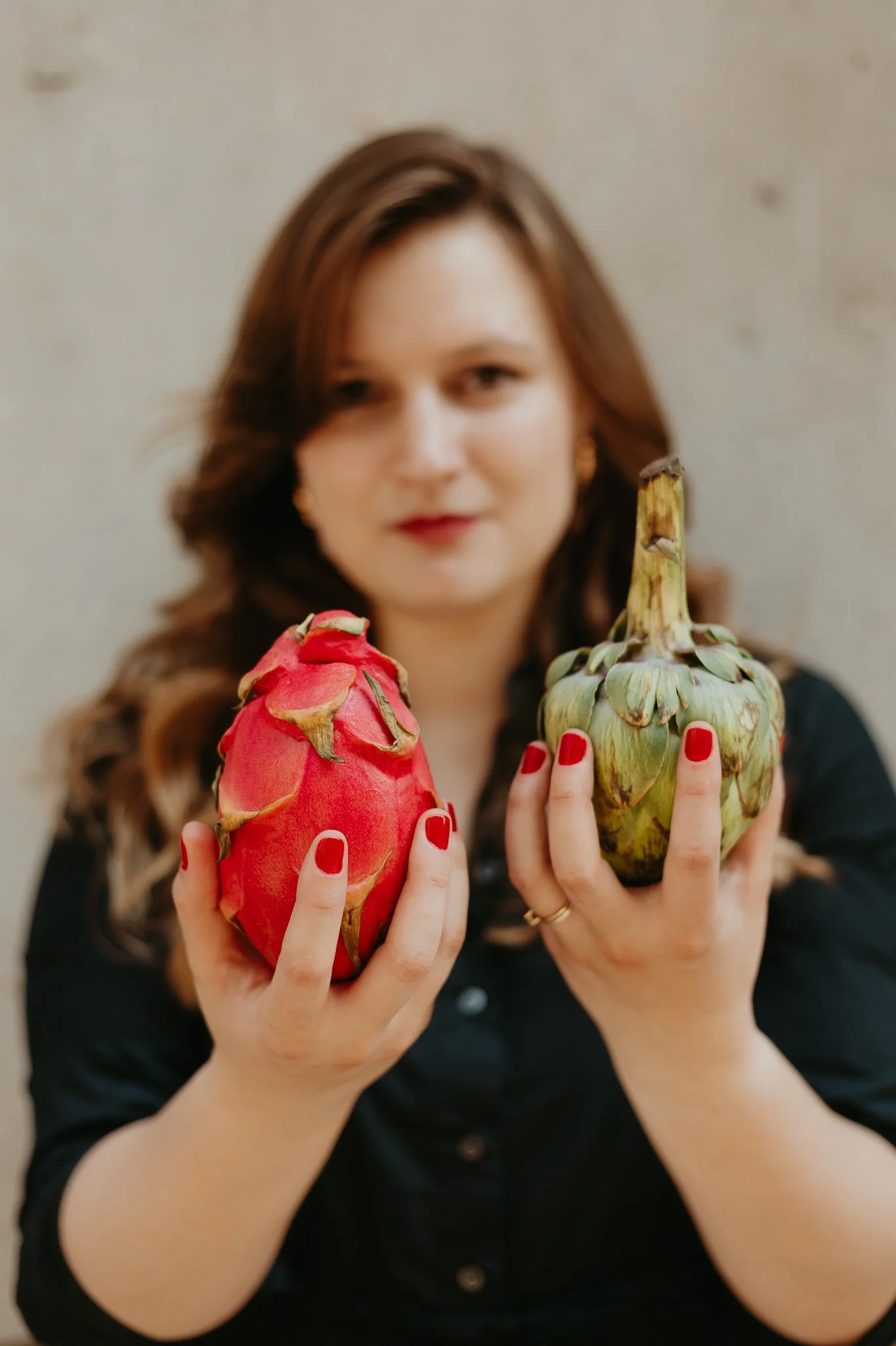 Three small dessert cups with layers of cake, pudding, and toppings on a wooden surface. The front cup has a "Dulce Paradise" sticker, topped with chocolate shavings, with a chocolate and yellow cake layer visible inside.