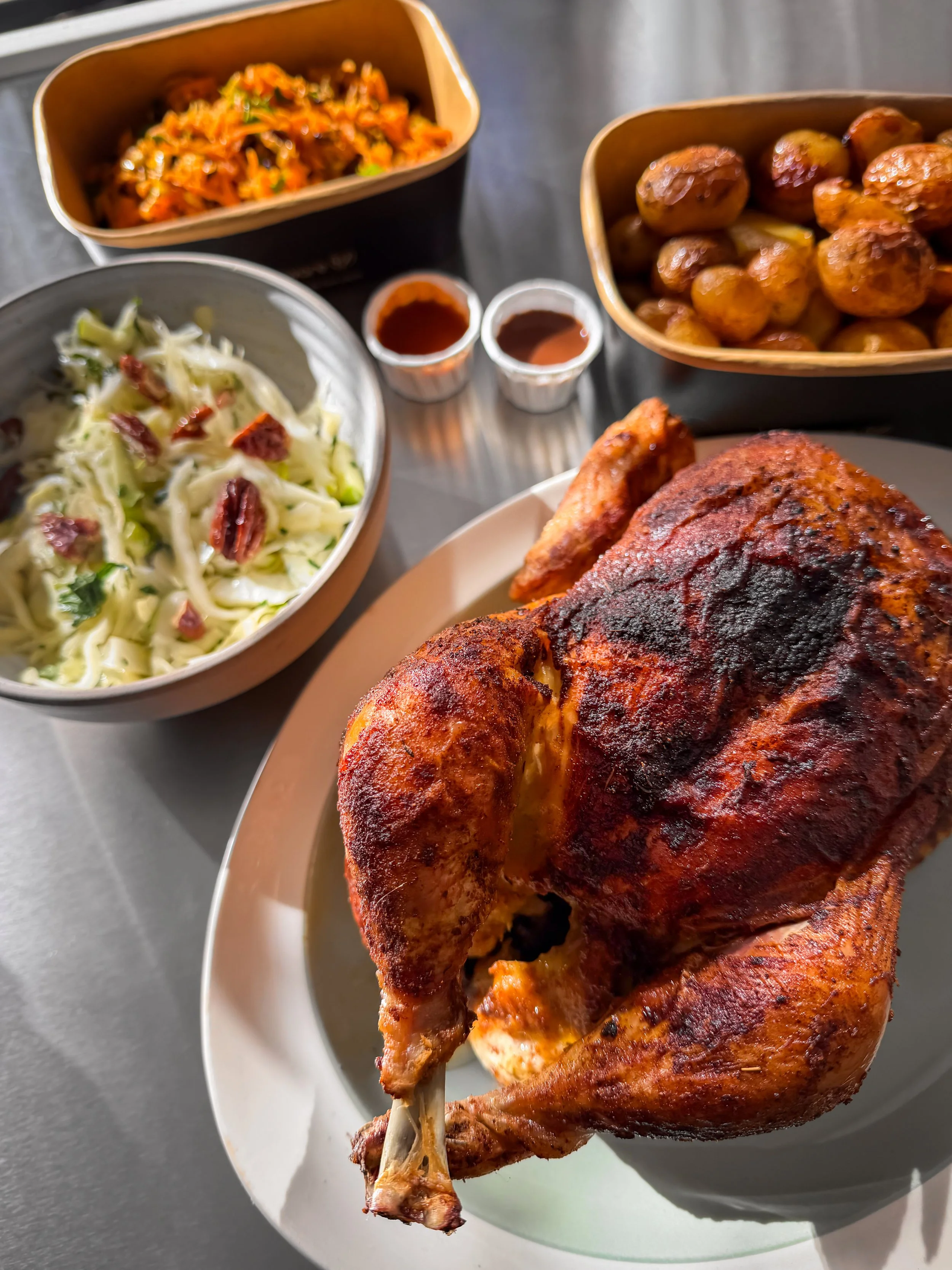 Whole Rotisserie chicken + 2 large sides + hot sauce
