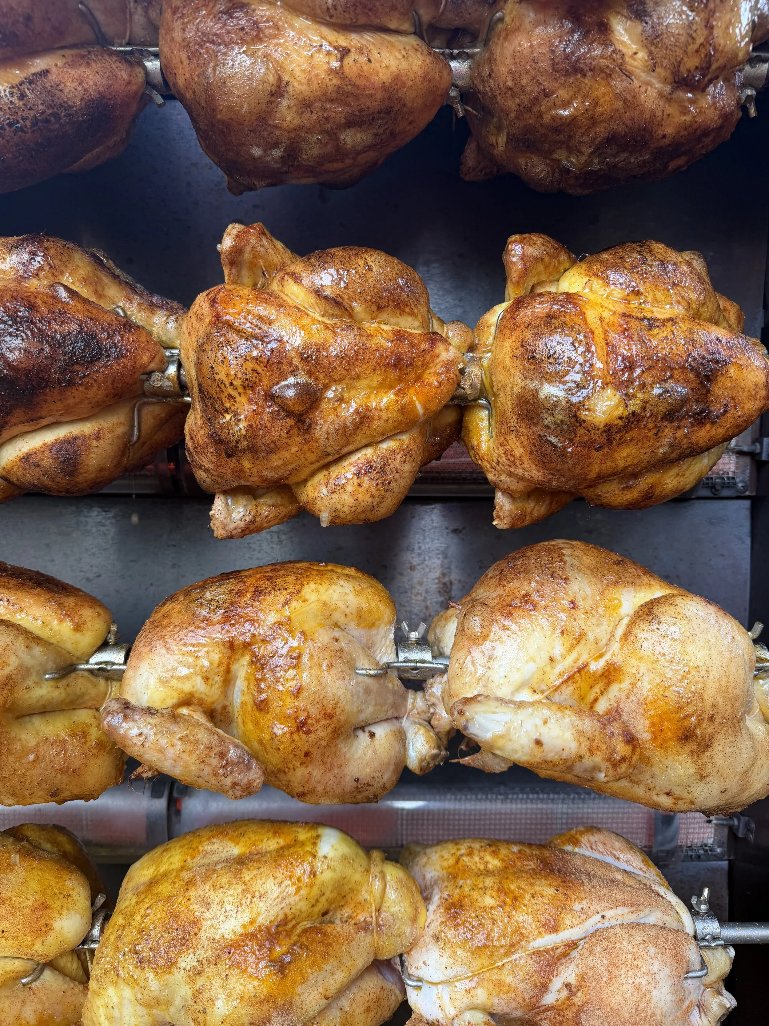 Spit rotisserie chicken with potatoes