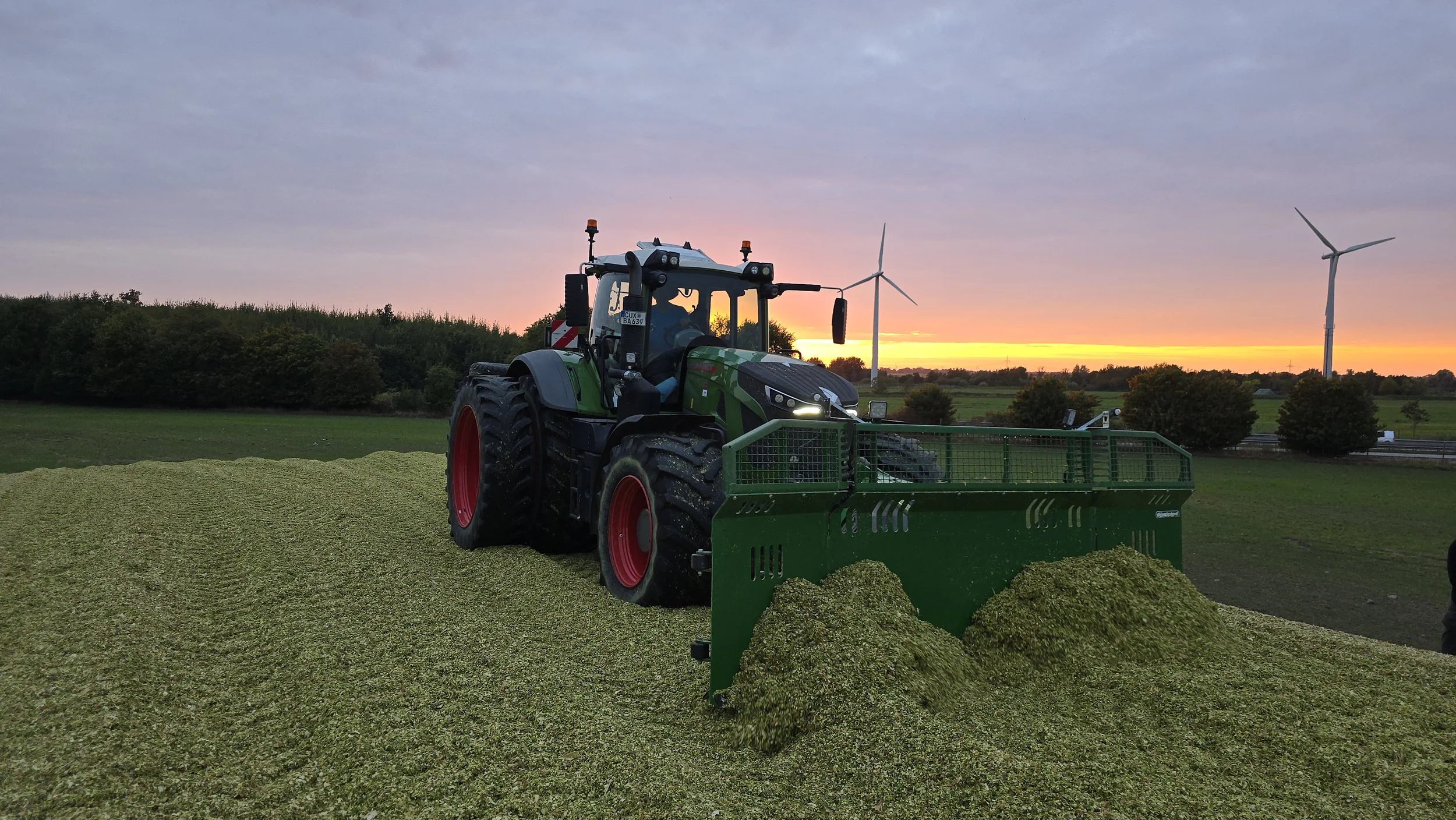 LIVAG showing green tractor with background sunset