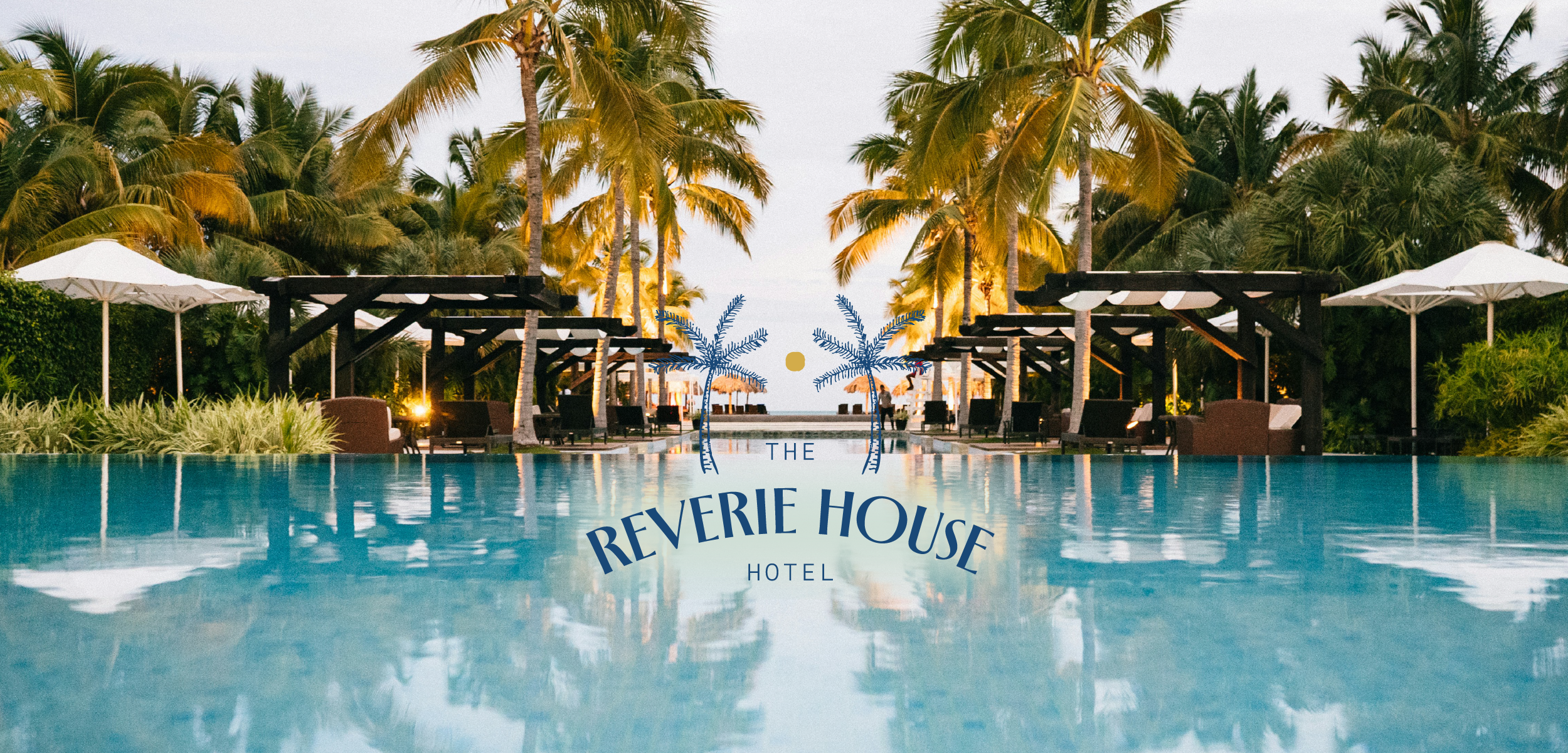 A resort pool area with palm trees, lounge chairs, umbrellas, and a sunset view in the background, with the text 'The Reverie House Hotel' in the center.