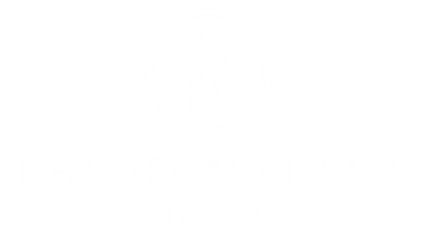 Logo of The Iron Horse Hotel featuring a stylized horseshoe and the hotel name.