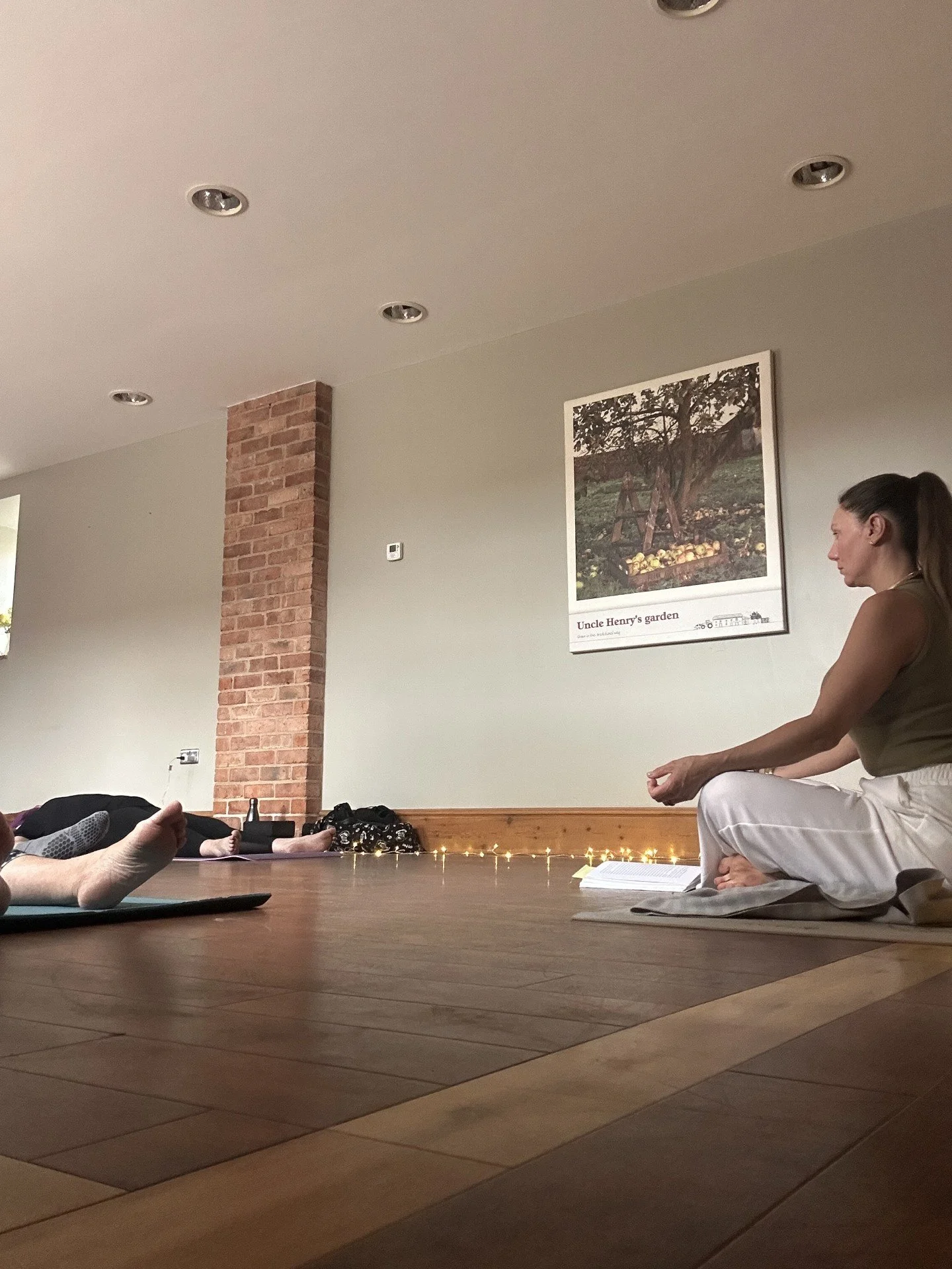 Amanda seated in a room with students laying down