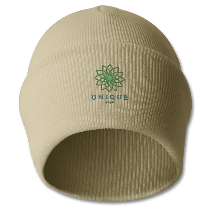 Beige knit beanie hat with a green embroidered logo of a flower and the text 'UNIQUE yoga'.