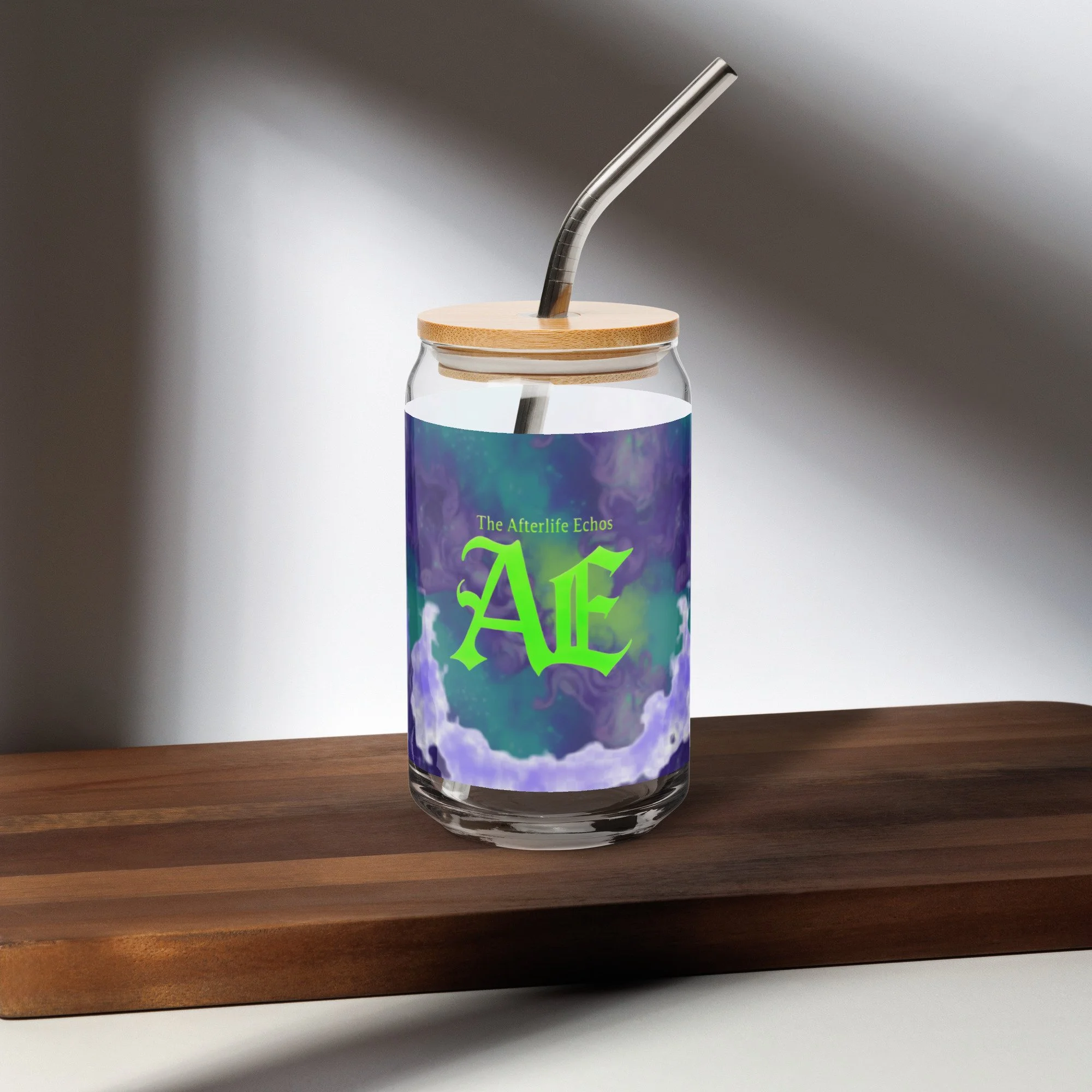 A glass jar with a wooden lid and metal straw, labeled 'The Afterlife Echoes' with a purple and green abstract design, placed on a wooden surface.