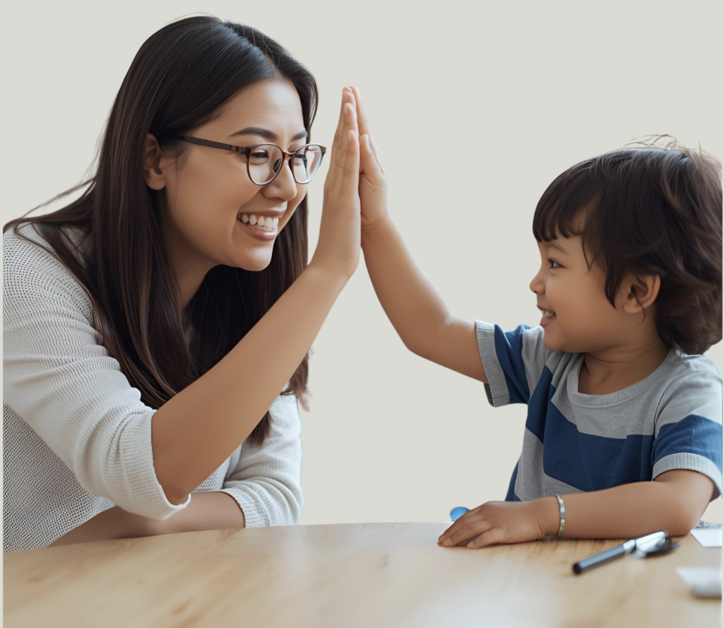 A woman and a young boy giving each other a high five, smiling at each other.