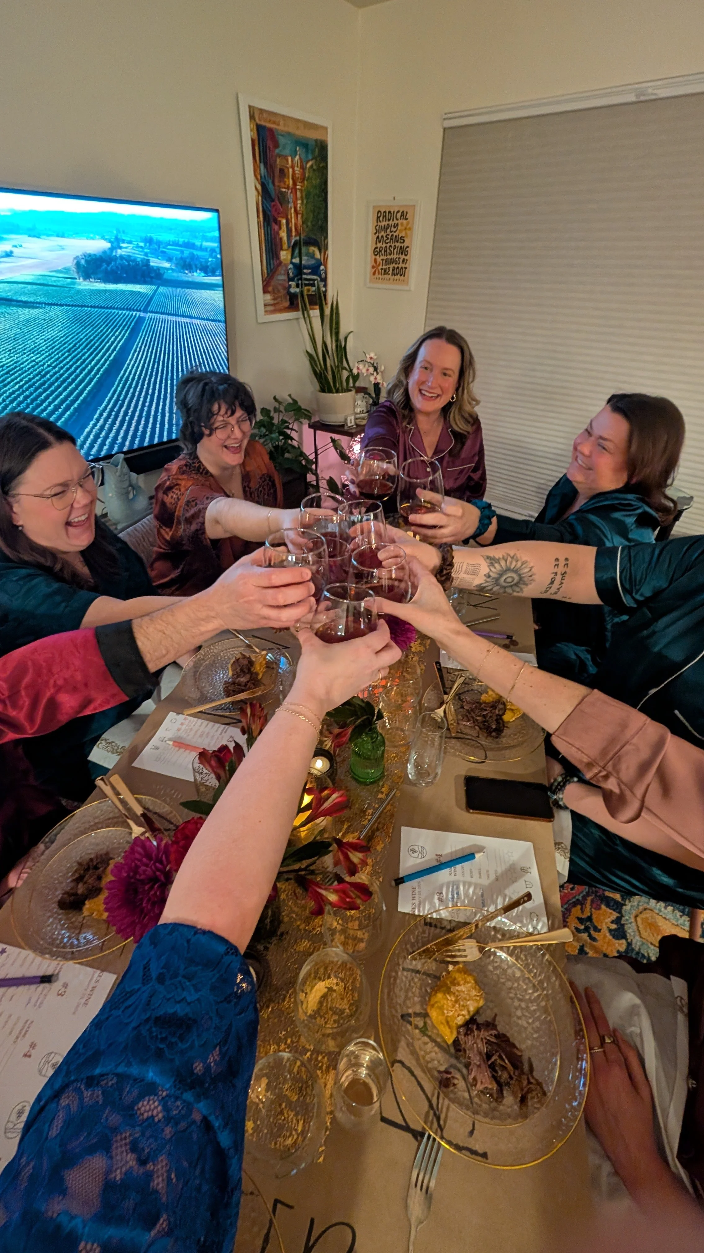 Cheers at a table during an in-home wine tasting