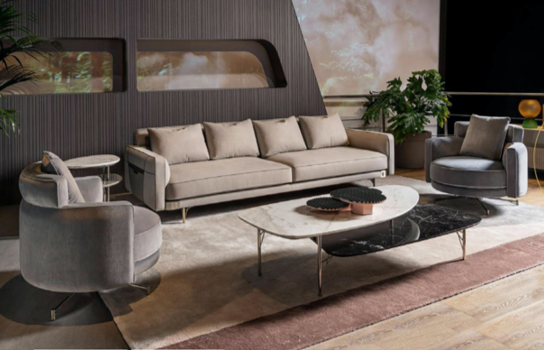 Modern living room with a beige sofa, two gray swivel chairs, a rectangular coffee table, a large window, and a potted plant.