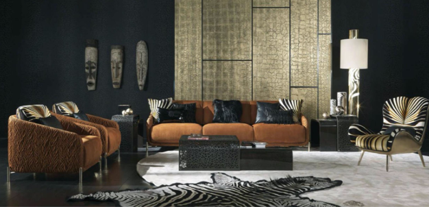 Modern living room with dark walls, gold wall art, black and gold decorative masks, brown velvet sofa, black side tables, striped armchair, black and white zebra rug, and a tall white lamp.