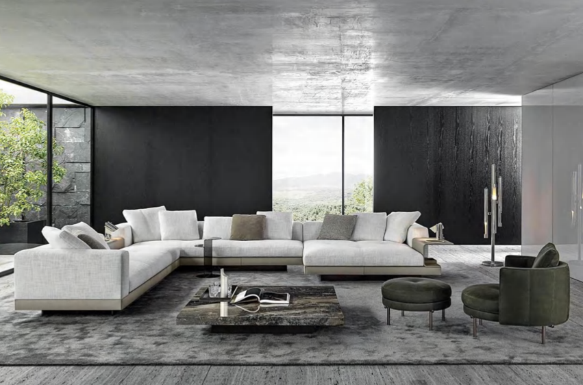 Modern living room with large white sectional sofa, two green armchairs, a dark stone coffee table, and floor-to-ceiling windows showing greenery outside.