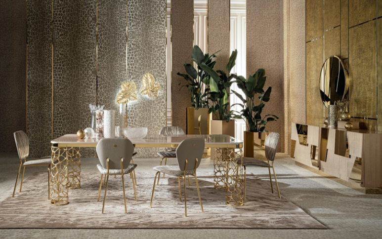 Elegant dining room with gold accents, leafy plants, and decorative objects on sideboard.