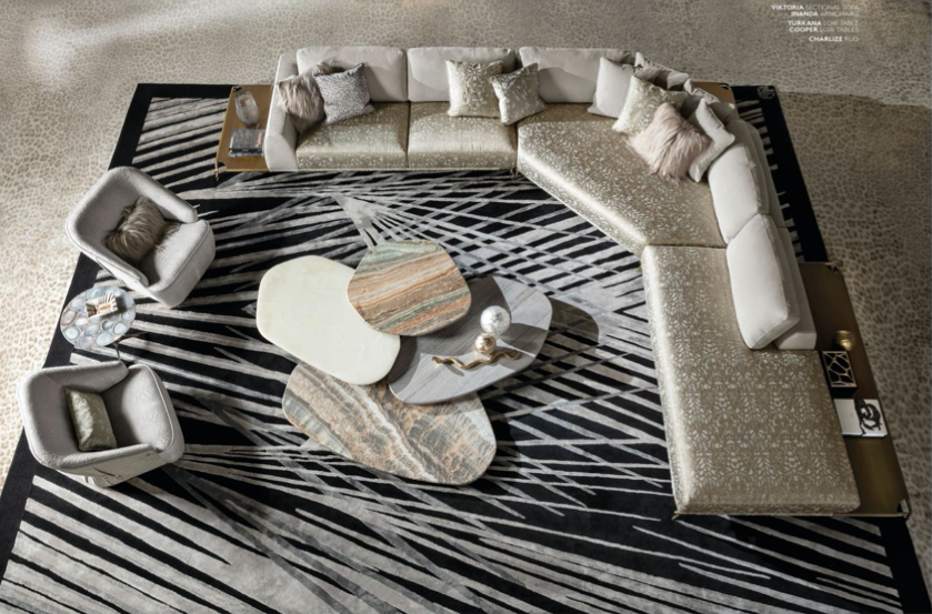 Top-down view of a modern living room with a large L-shaped sofa, two armchairs, and three overlapping coffee tables on a black and white patterned rug.