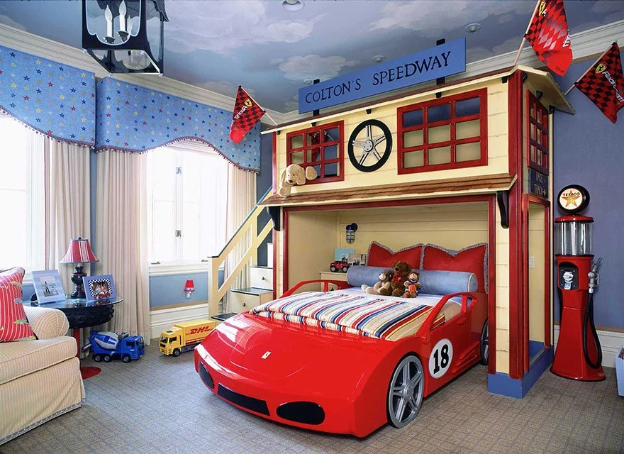 Child's bedroom decorated with a racing car bed, race flags, and NASCAR-themed decor.