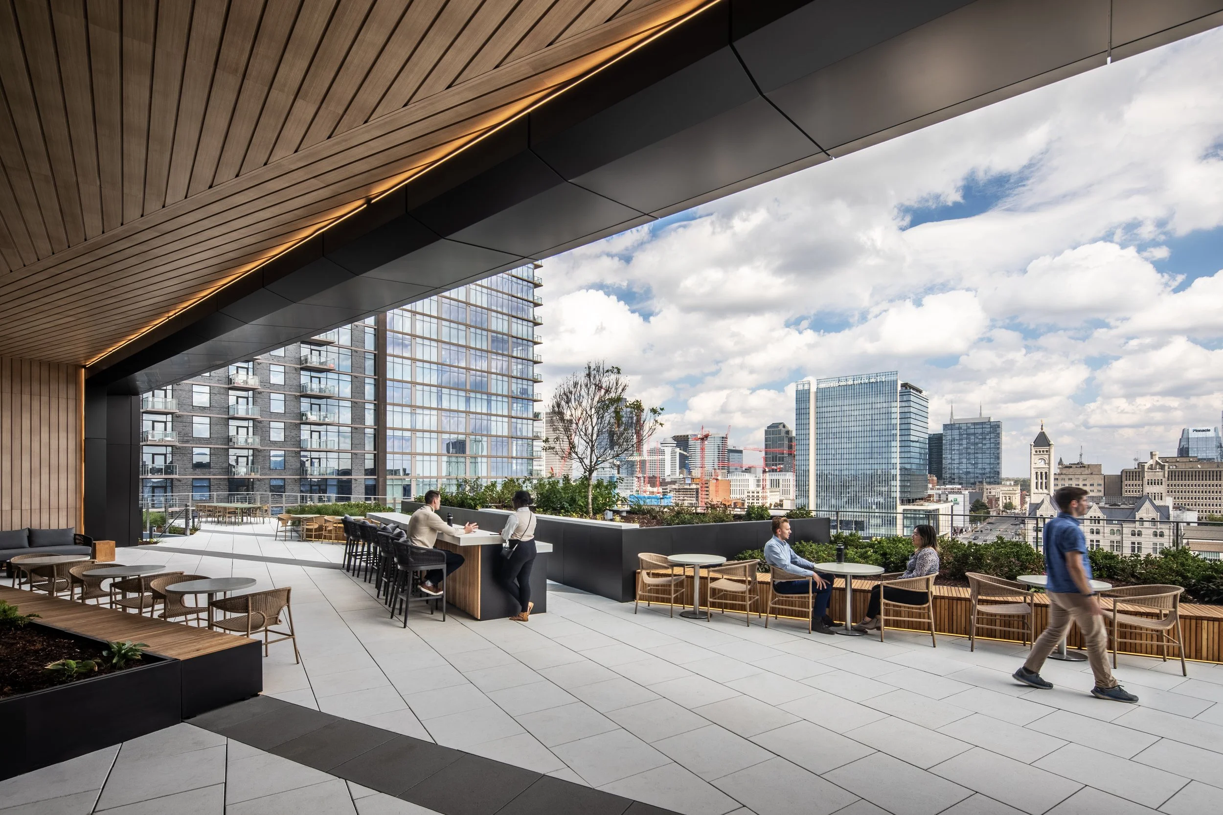 Flex indoor/outdoor space of a common area for a large office high rise building in a downtown urban setting.