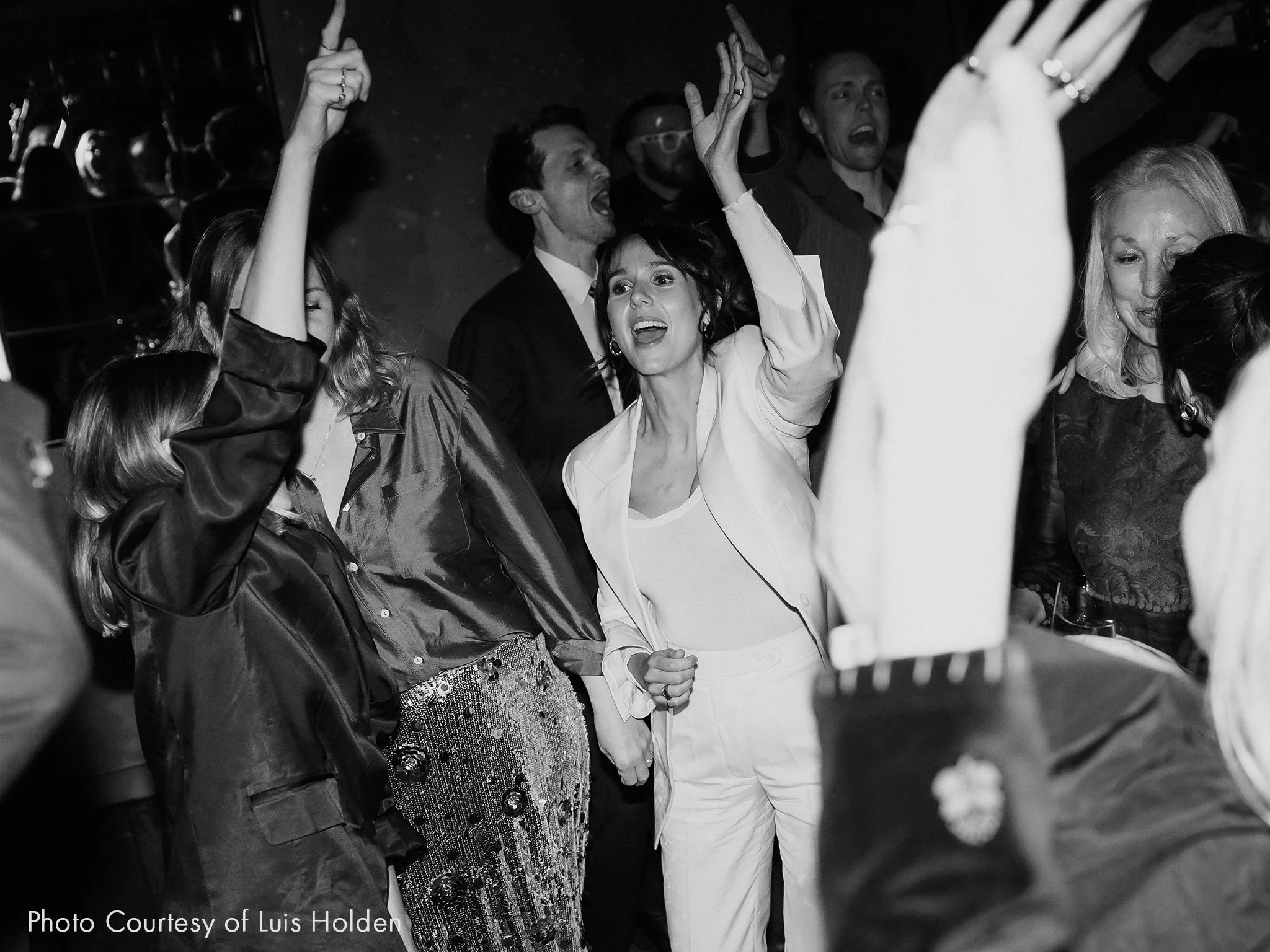 People dancing and celebrating at a party or event in a lively atmosphere.