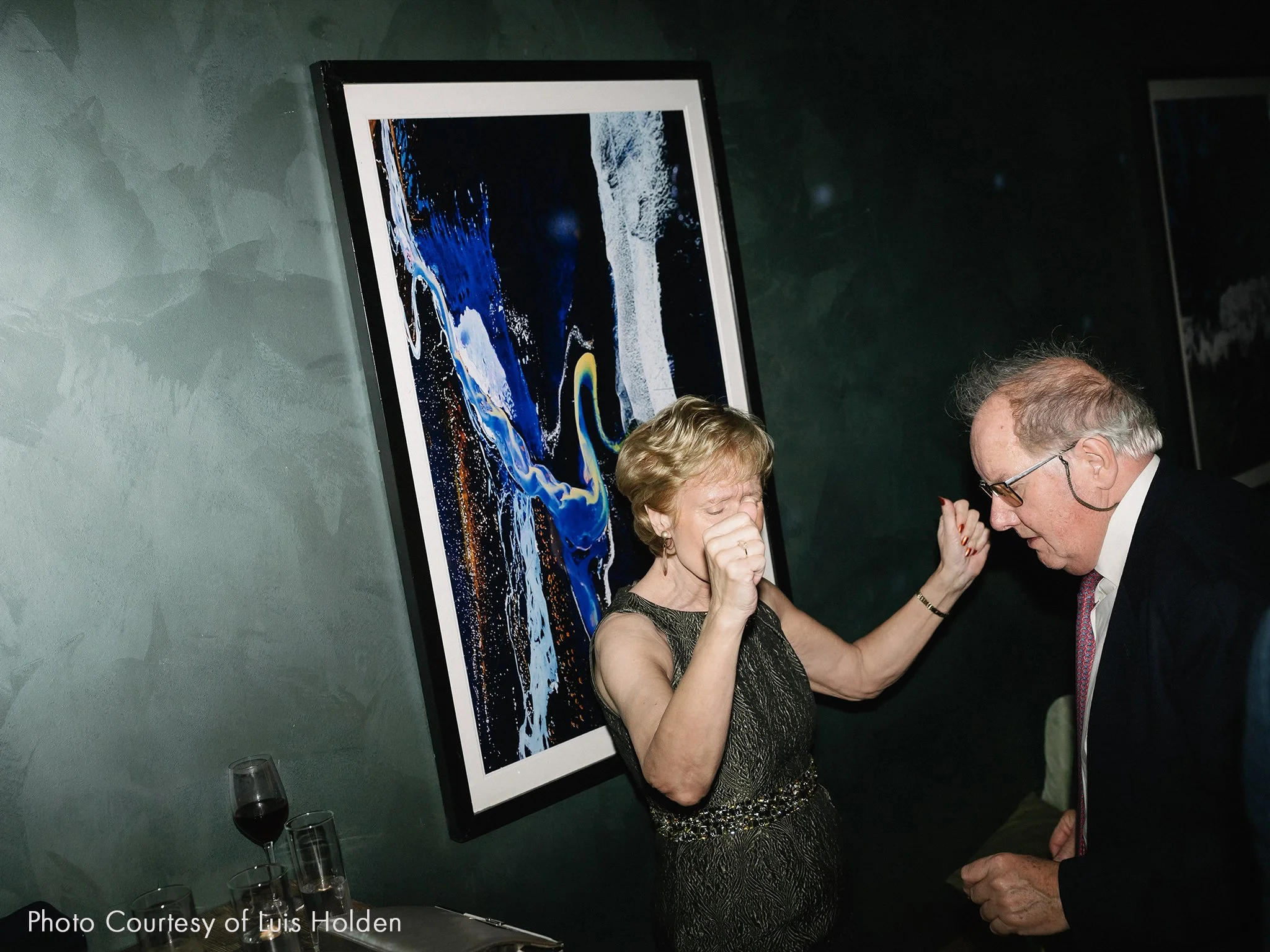 An elderly woman and man are dancing at an event, both are enjoying the music and deep in emotion.