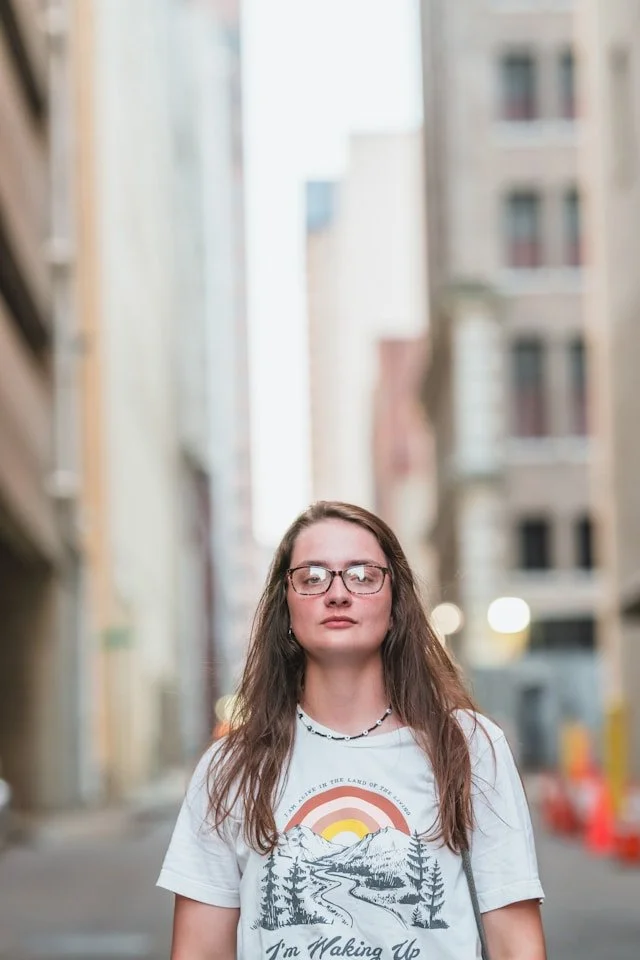 Professional woman standing confidently, representing the self-awareness, resilience, and success supported by ADHD coaching for women.