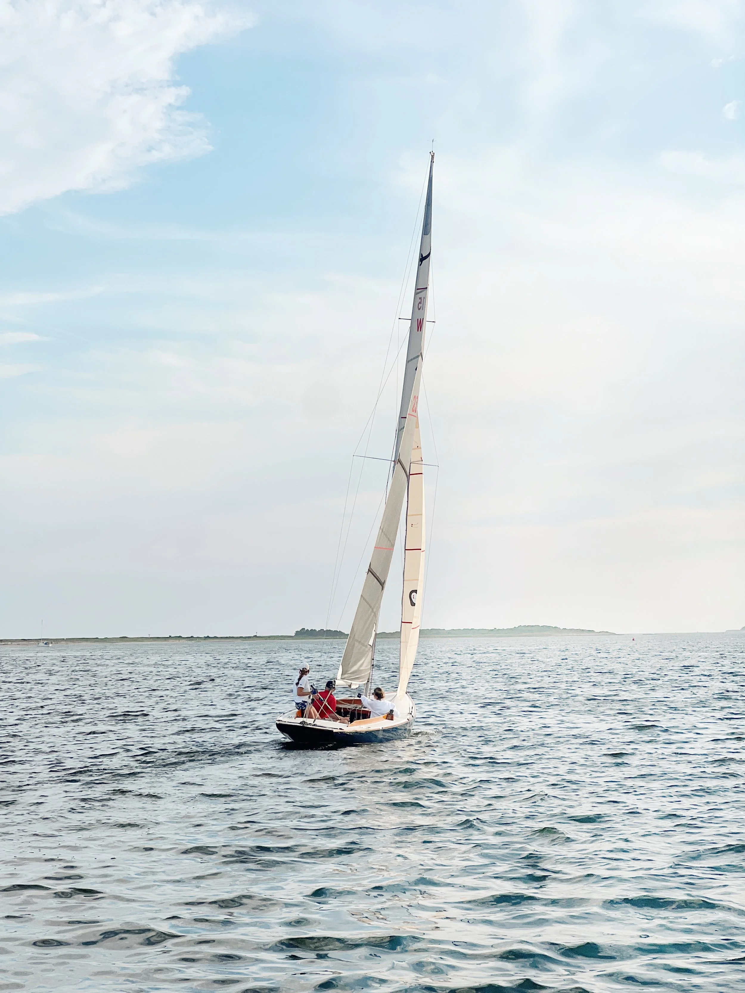 People sailing on a sailboat on the water during the daytime.
