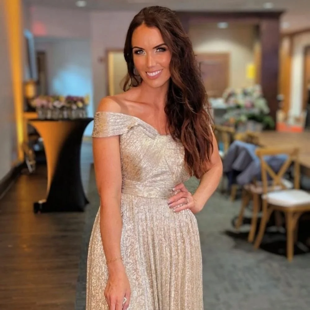 Female client in gold formal dress with a natural spray tan