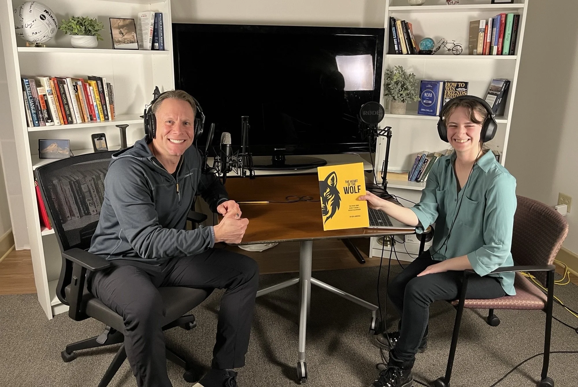 A man has just finished recording an audiobook in the studio beside the sound engineer.