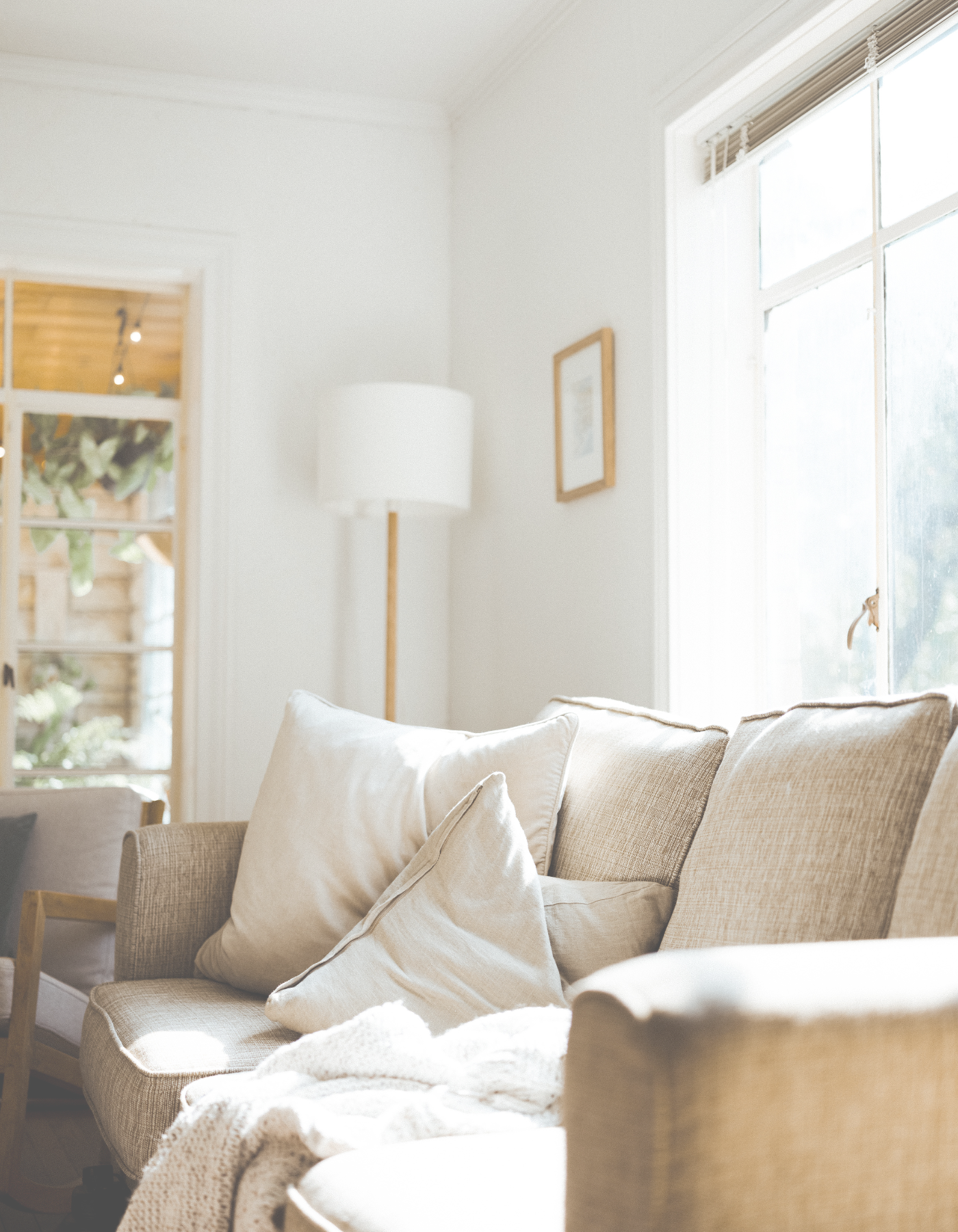 Therapy office seating area with soft furnishings and natural light.