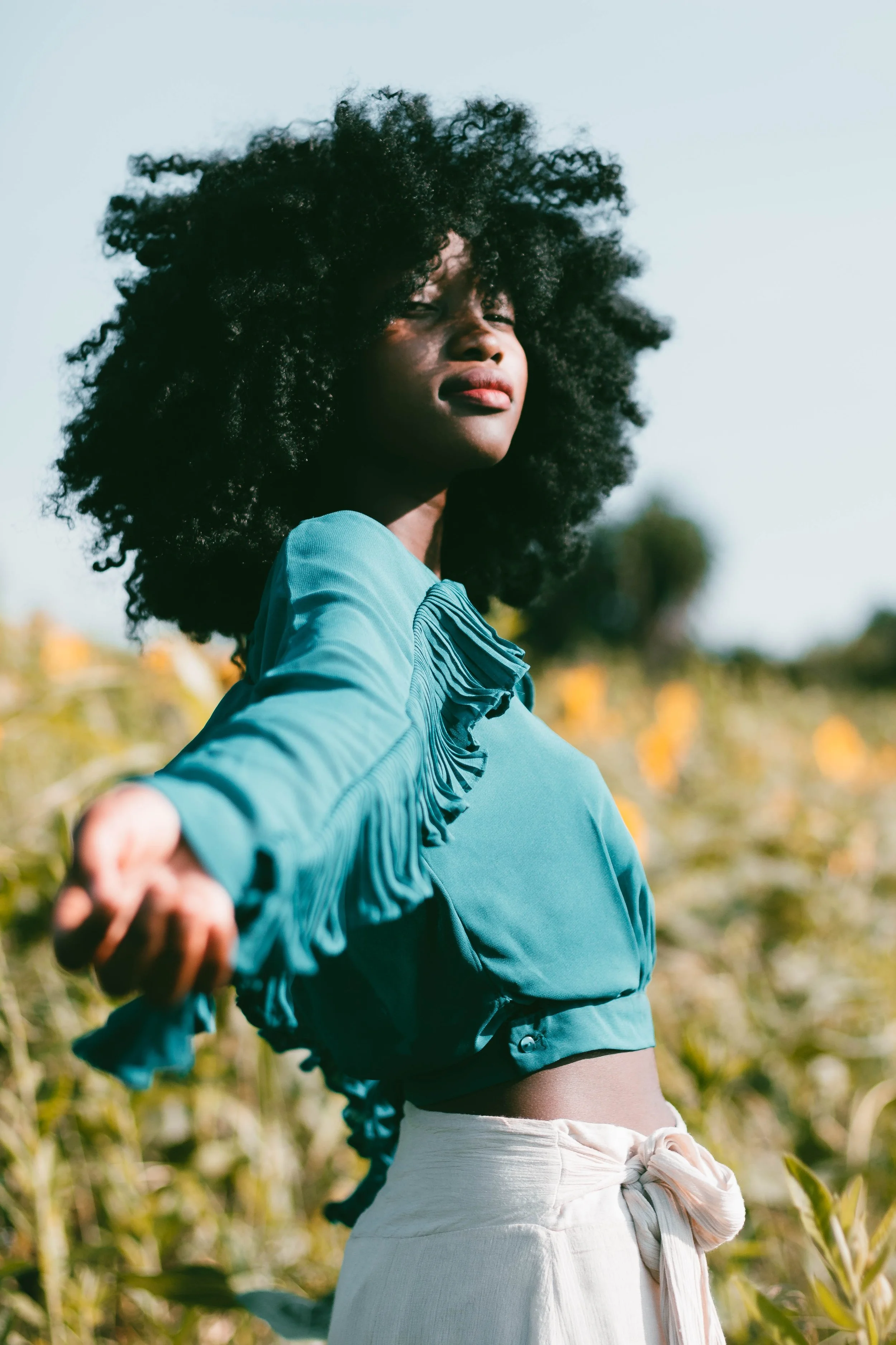 Woman standing in a field and reaching out for help when they realized they were not sure what to do next.