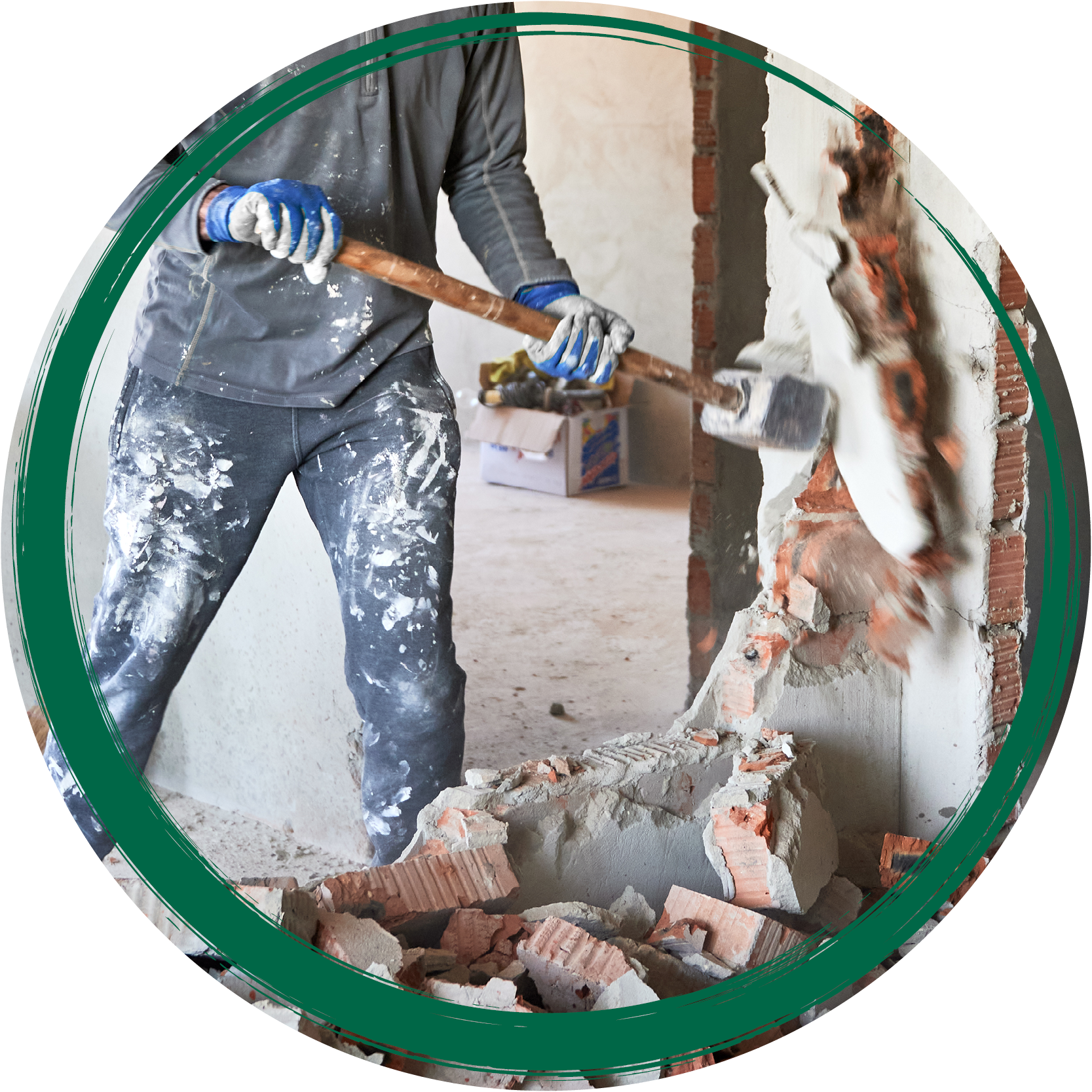 worker with sledgehammer, breaking down interior brick wall