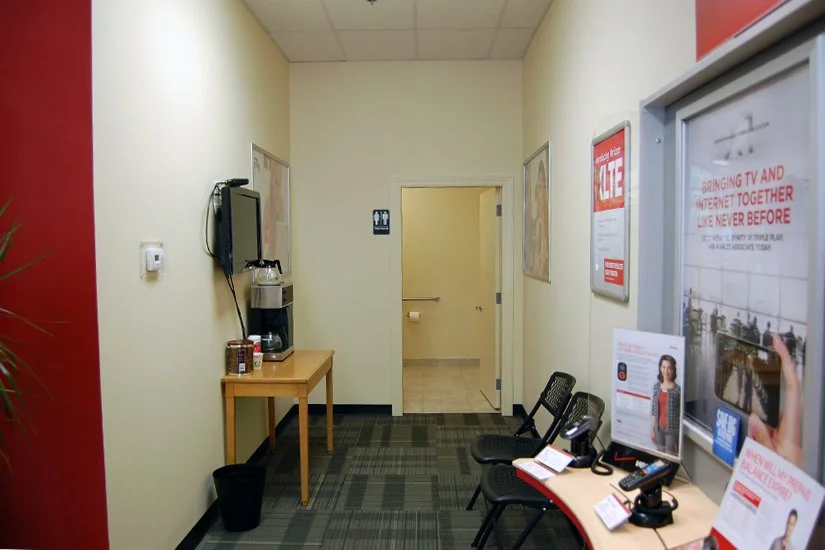 phone display in Verizon Wireless store, posters and marketing materials on the wall and table