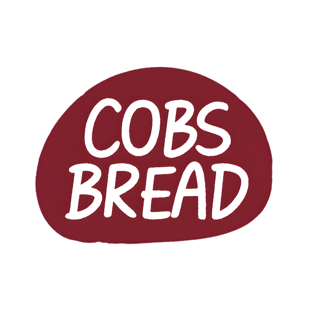 Red circular sign with white handwritten text that says 'COBS BREAD'.
