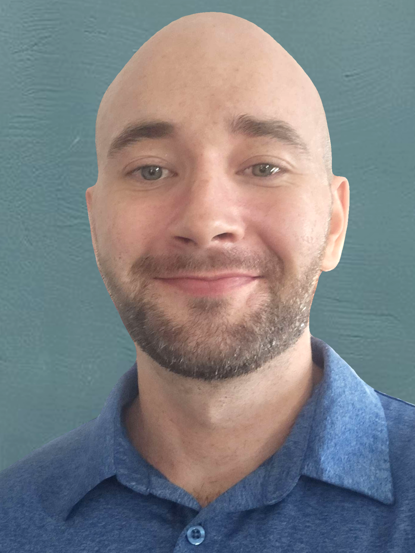A man with a bald head, light skin, a beard, smiling with a blue shirt against a textured teal background.