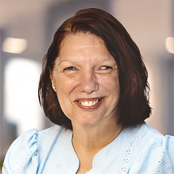 Portrait of a smiling Luna Bengio wearing a powder blue blouse.