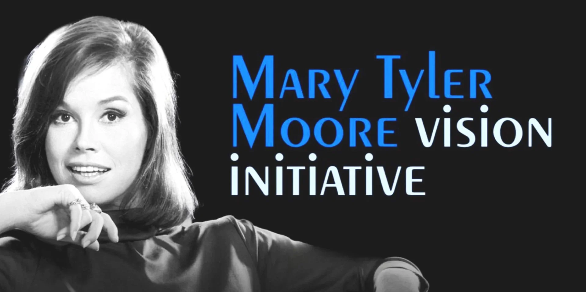 Promotional banner for the Mary Tyler Moore Vision Initiative, featuring a black and white portrait of May at the peak of her fame, layered on a black background with the initiative's branded wordmark in blue text on the right.