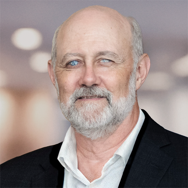 Portrait of a smiling Ian White wearing a white collared shirt and a black blazer.