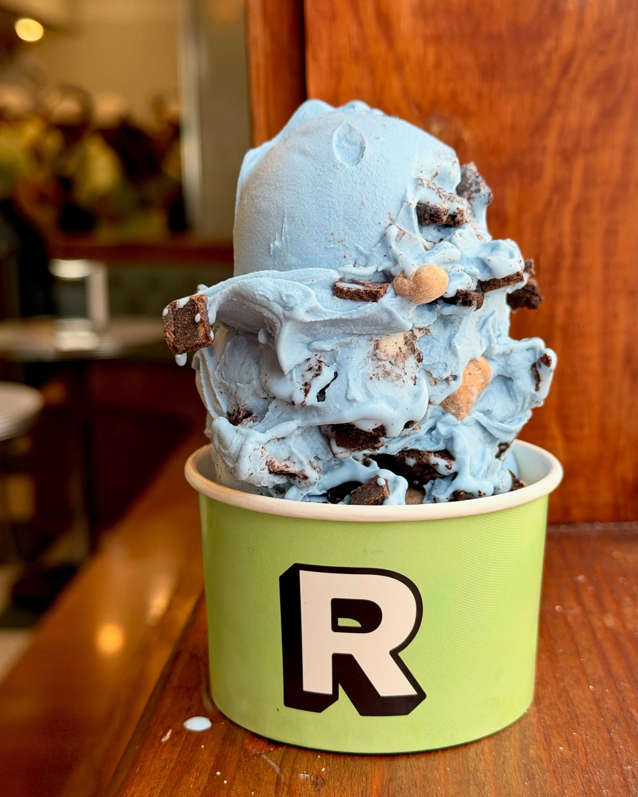 Foreground: Today's Flavor of The Day, Cookie Monster: Blue Vanilla Custard with Oreo, Cookie Dough, and Chocolate Chips 

Background: The employees who insisted that the natural Blue food coloring does, in fact, make the Vanilla taste better.

Does 