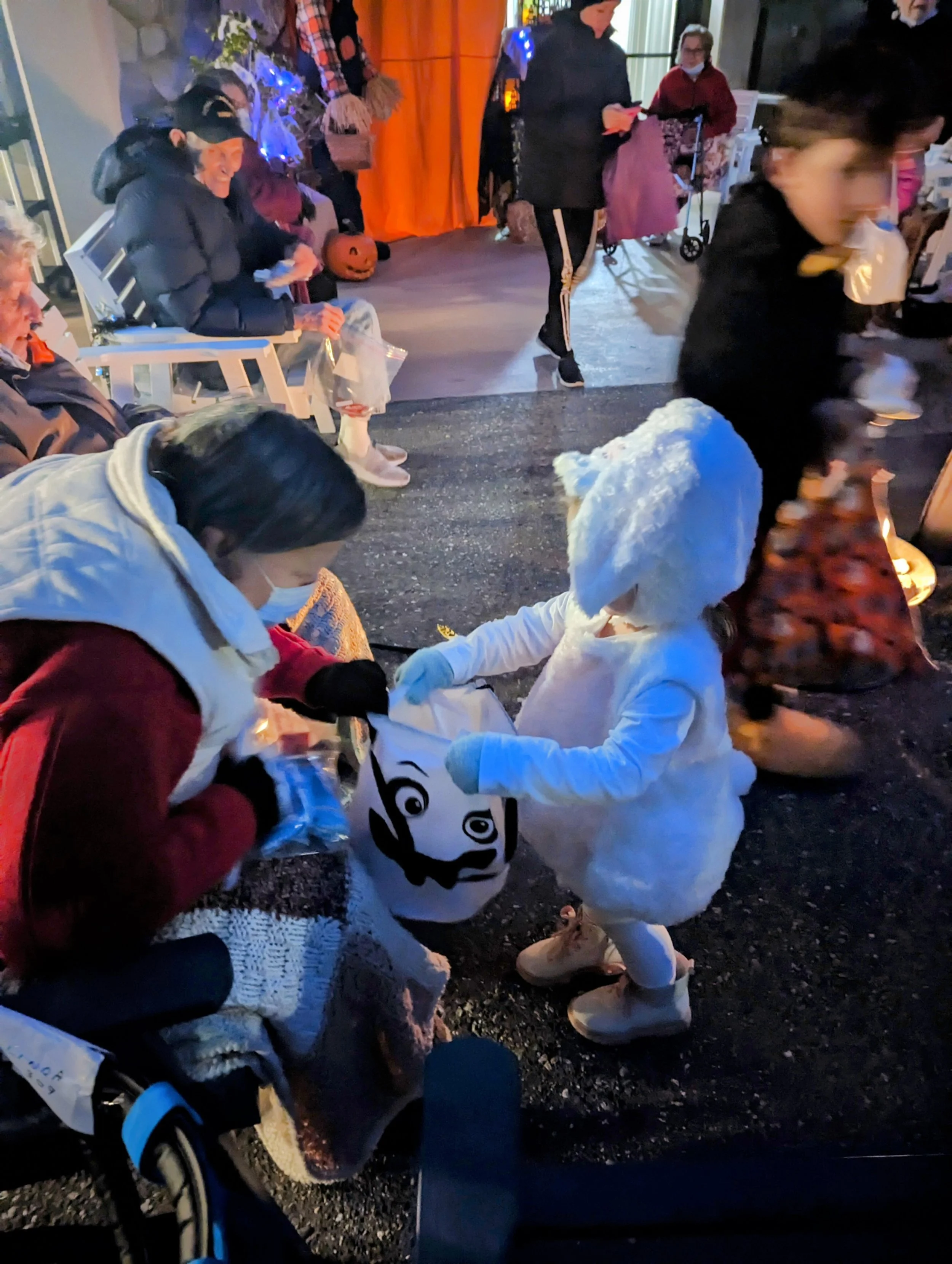 Resident giving child Halloween candy.jpg