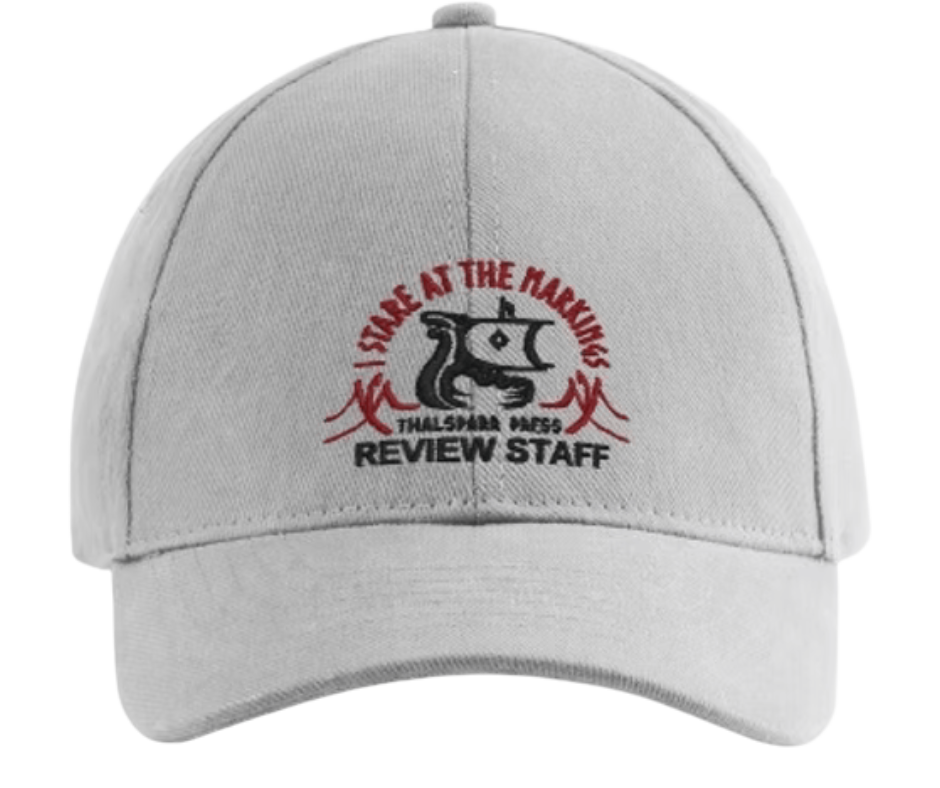 White baseball cap with embroidered logo of a dragon and text that reads "ISLE AT THE MARINAS THALSHARK PASS REVIEW STAFF."