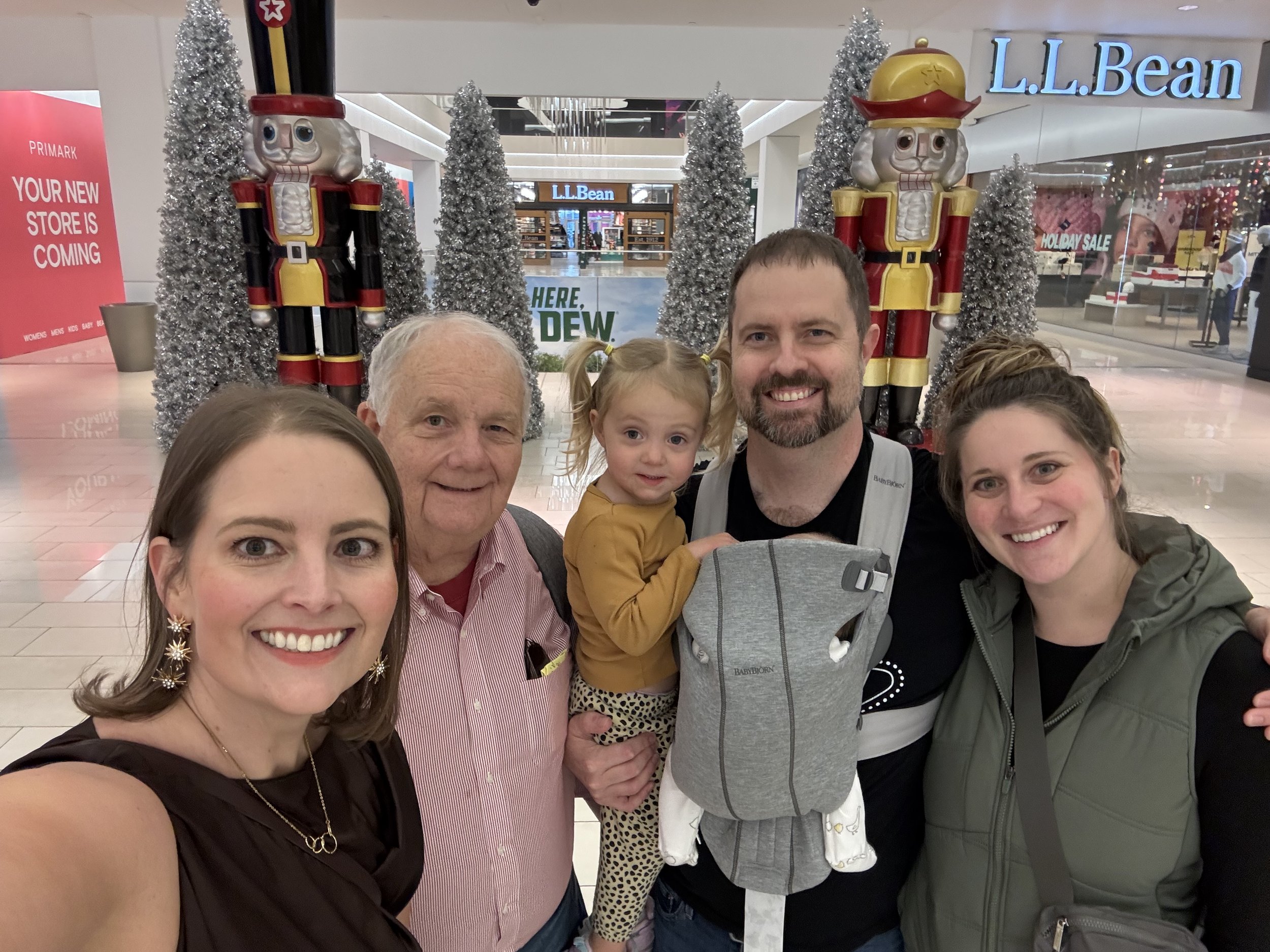 The Moss Family taking a selfie at the Mall of America in Minneapolis, Minnesota, decorated with Christmas trees and nutcracker statues.