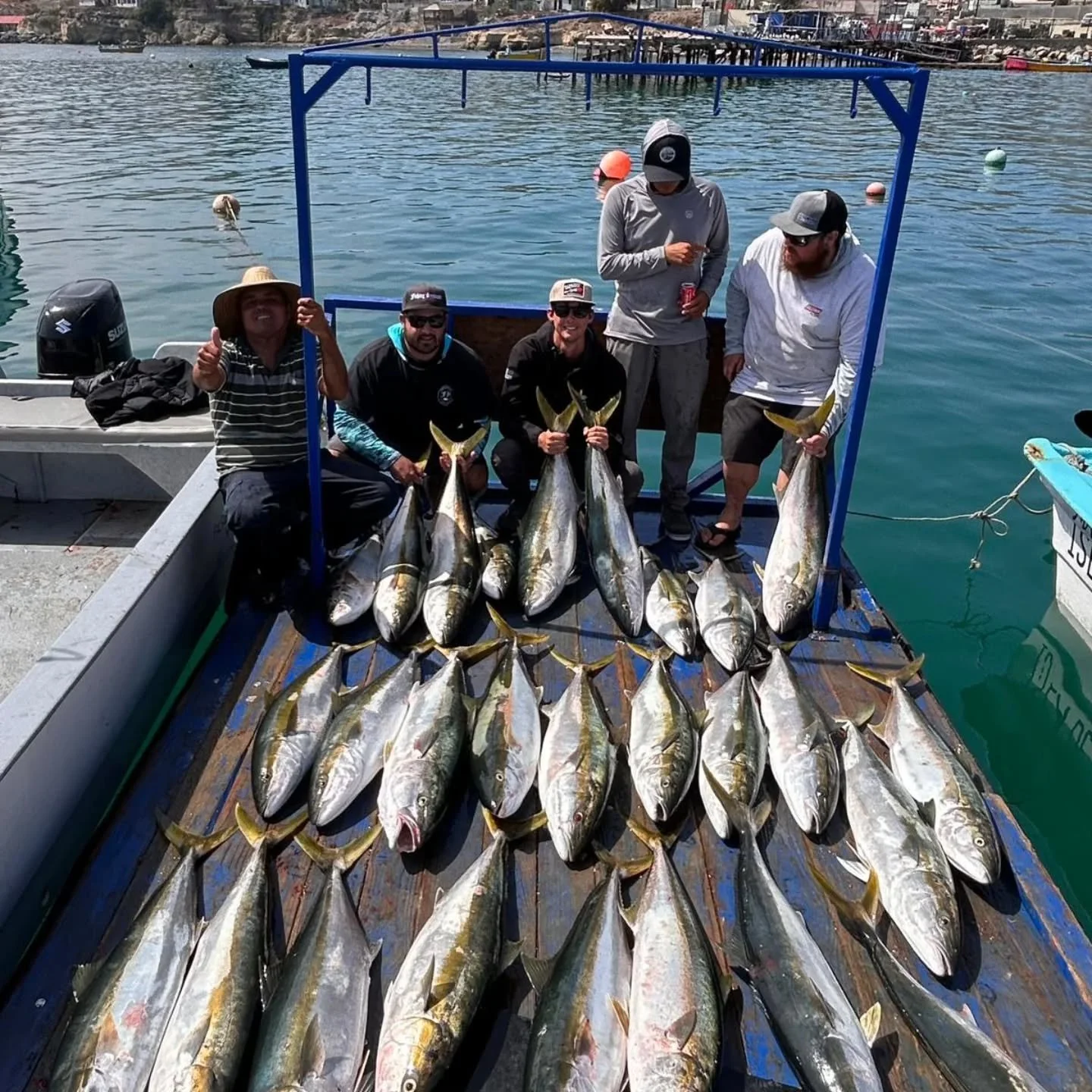 Anglers with a yellowtail haul on the dock after a Cedros Island sportfishing day.