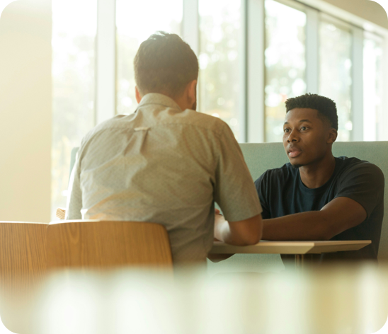 Two people sitting across from one another at a table