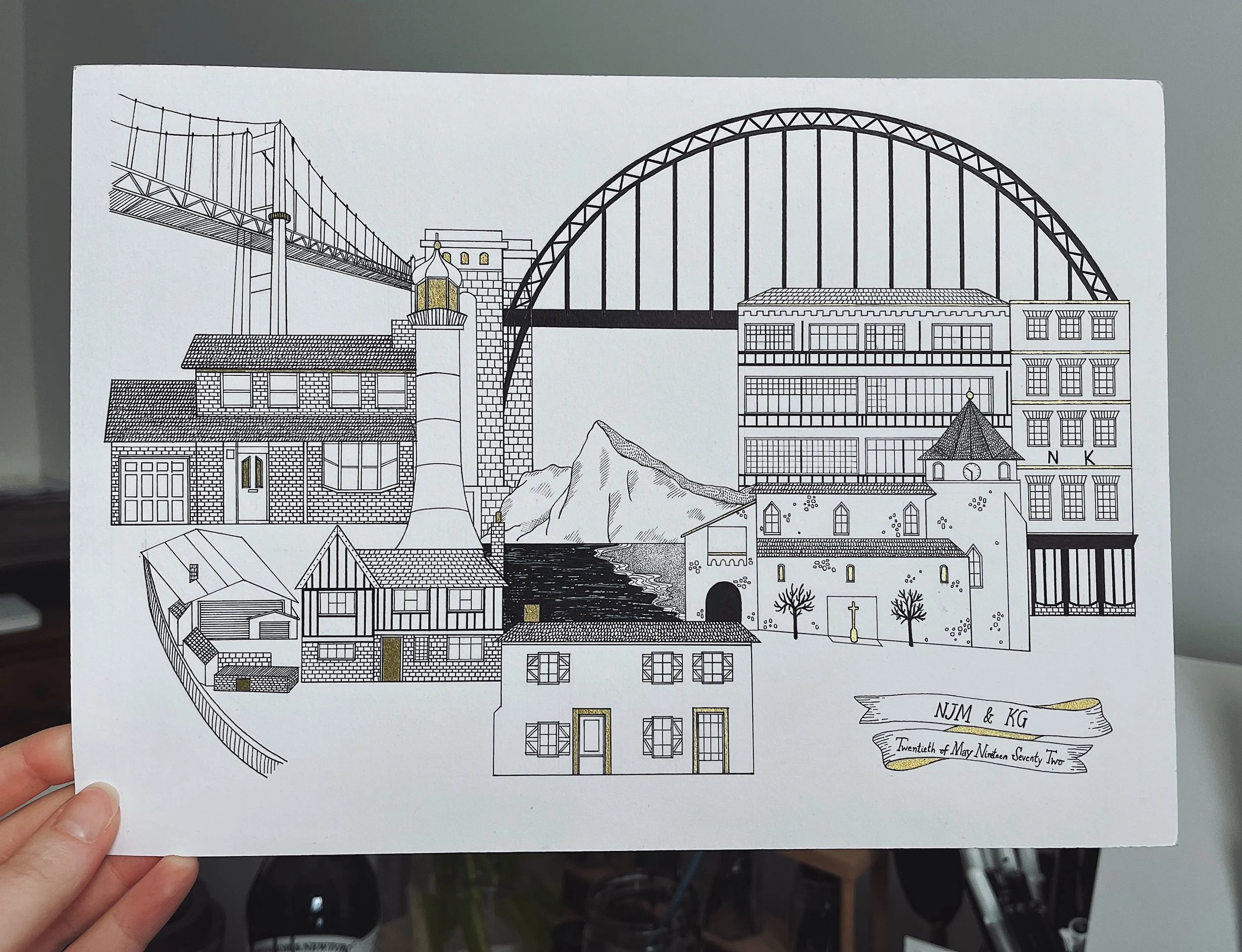 Black and white illustration of a cityscape with various buildings, a bridge, a mountain, and water, with the names NJM & KG and the date May 21, 1972.