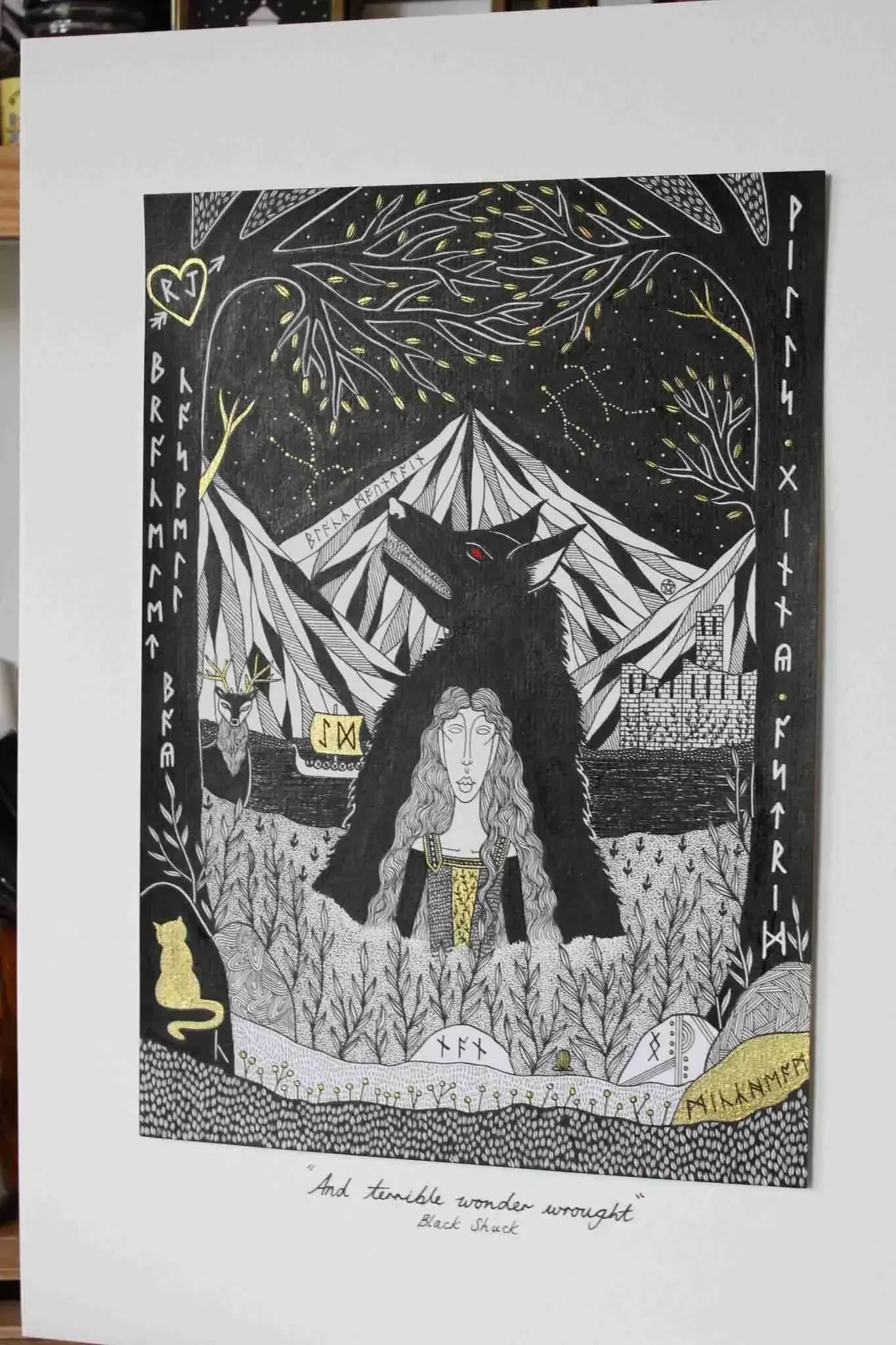 Black and white drawing with gold accents featuring a woman with long wavy hair, a large wolf with red eyes behind her, a mountain landscape, stars, trees, and Celtic symbols, with some words and phrases like 'And terrible wonder wrought.'