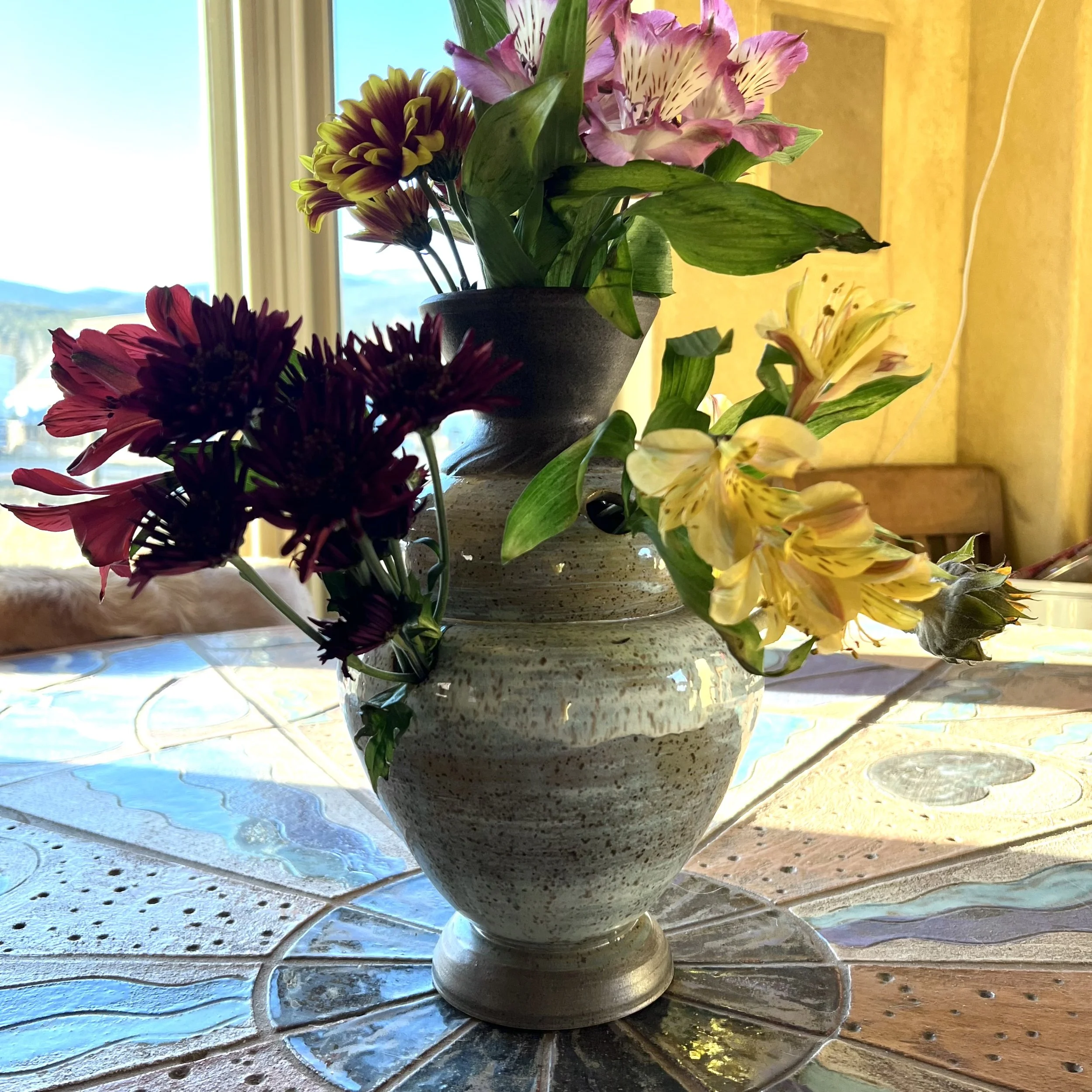An inexpensive bouquet displayed in a ceramic tullipiere I designed and created. Wheel-thrown stoneware.
