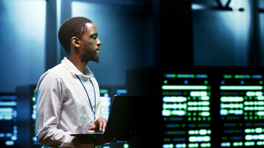 A man works in a technology control center