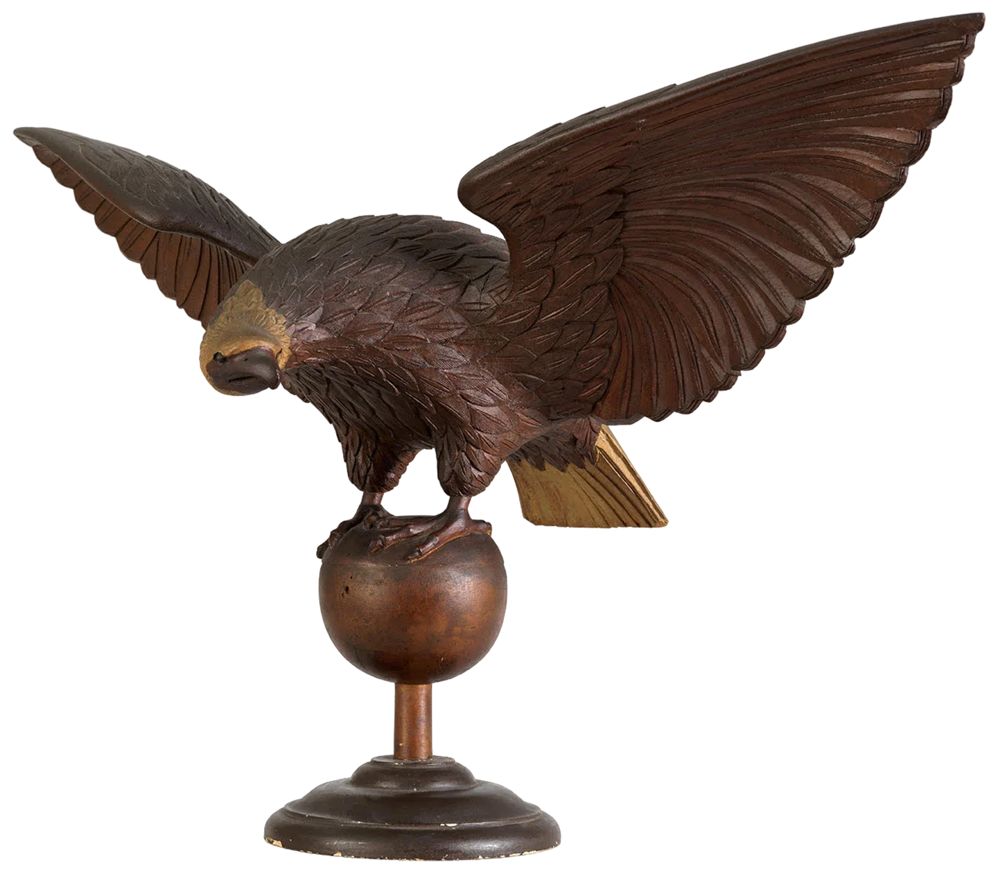Carved wooden eagle statue with wings spread, perched on a rounded base.
