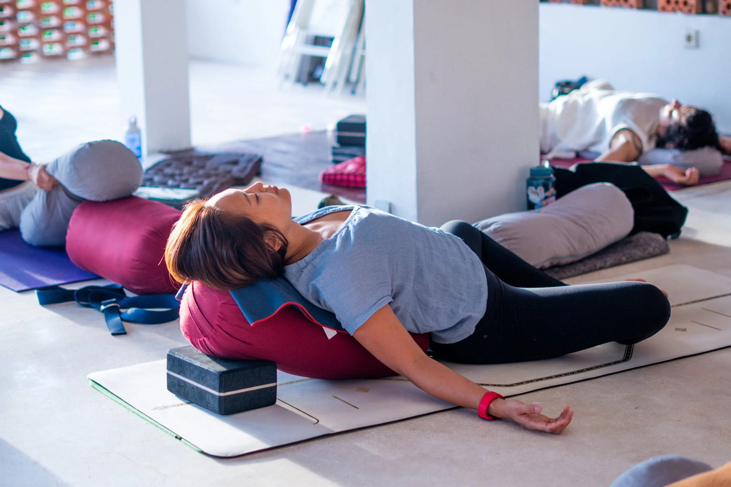Woman practicing yin yoga in a reclined butterfly posture